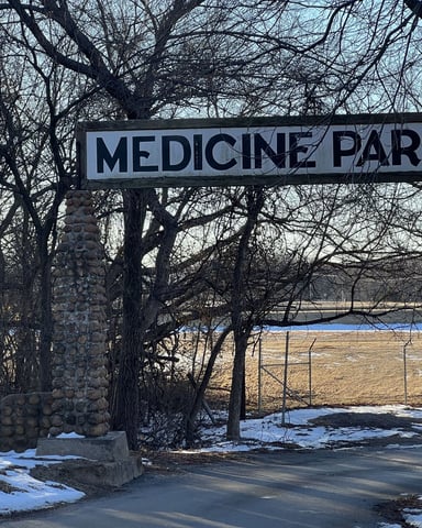 Medicine Park entrance sign and cobblestone road