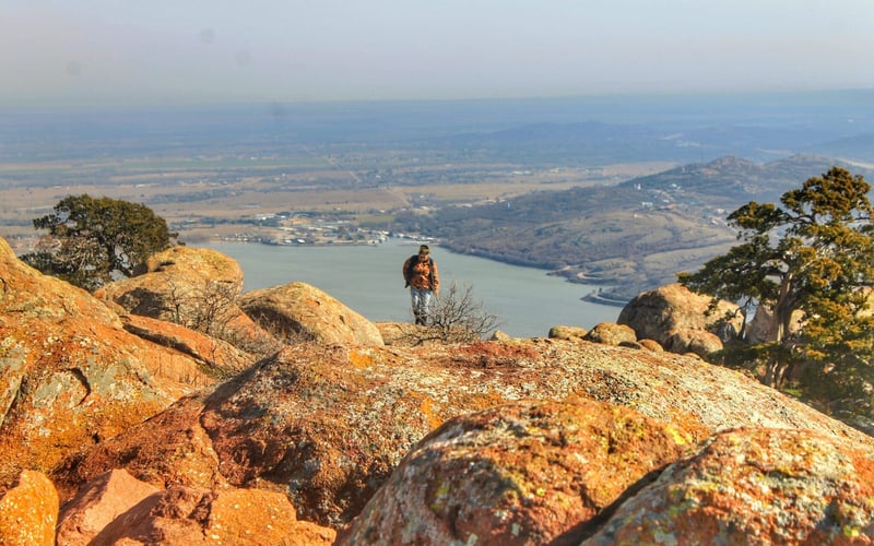Hiker on Mt. Scott overlooking Lake Lawtonka