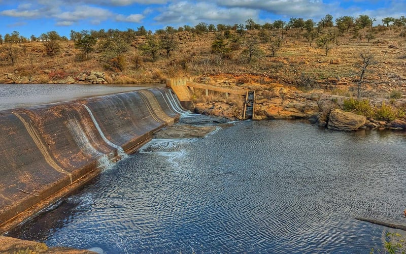 Medicine Creek dam and swimming hole with blue sky